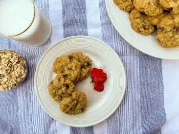 overhead shot of oatmeal cookies with plated cookies and milk